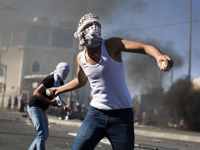 Palestinian youths clash with Israeli Police near to the house of murdered Palestinian teenager Mohammed Abu Khdair. Photo by Ilia Yefimovich/Getty Images.