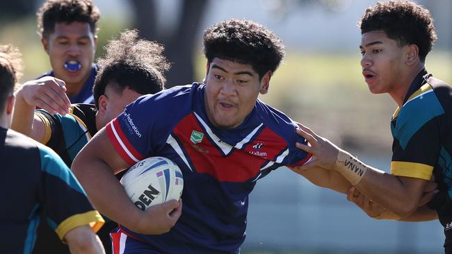 MELBOURNE. 11/05/2023.  Schoolboys Rugby League at Seabrook Reserve, Broadmeadows .  Hallam Senior College v Vic Uni Secondary College.  Ezekiel Tausili tries to charge through the tacklers  .Pic: Michael Klein