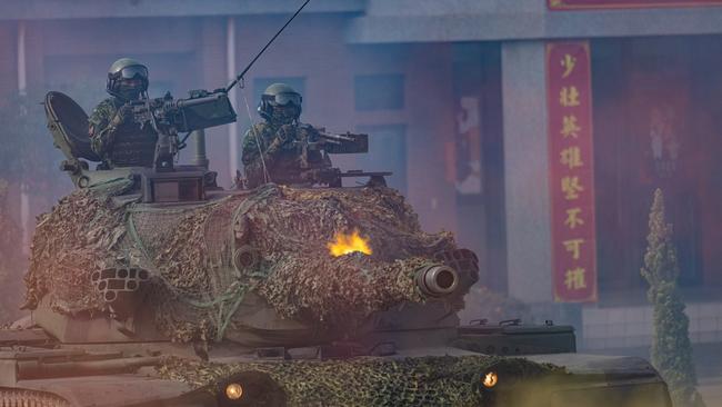 Soldiers fire on a CM-11 Brave Tiger battle tank during routine drills to show combat readiness Mandatory military service was tripled last year to 12 months. Picture: Annabelle Chih/Getty Images