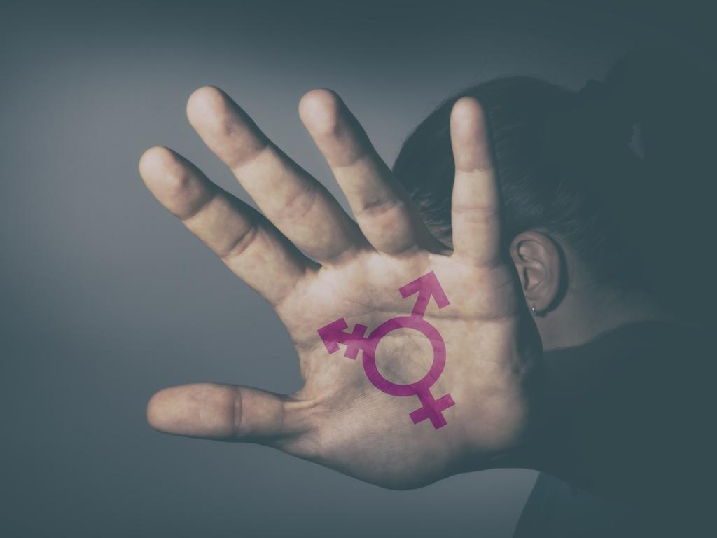 Transgender symbol painted in the palm of unrecognizable person. Istock