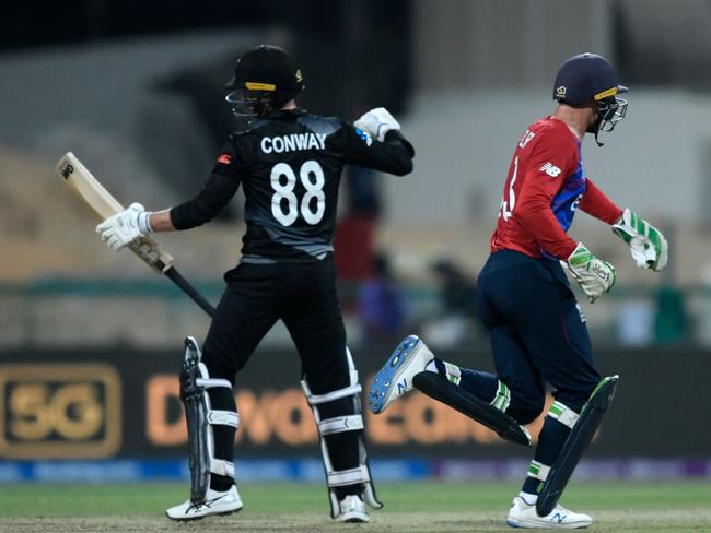 New Zealand's Devon Conway (L) reacts after he was stumped out by England's wicketkeeper Jos Buttler (R) during the ICC menâs Twenty20 World Cup semi-final match between England and New Zealand at the Sheikh Zayed Cricket Stadium in Abu Dhabi on November 10, 2021. (Photo by Aamir QURESHI / AFP)