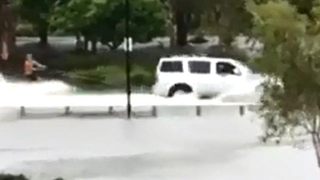 Surfers being towed behind a car at Emerald Lakes. Screenshot: Theo Kostoglou