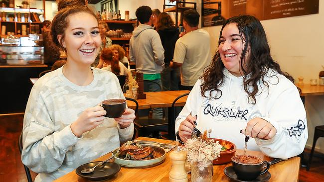 Healesville resident Jennifer Vermeulen, left, and friend Emma Debono at a cafe in town on Monday. Picture: Ian Currie