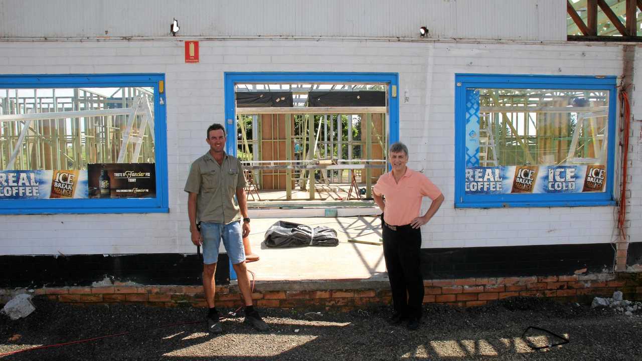 ON ITS WAY: Ross McPhee, right, stands with builder John Fazackerley out front of Rusty's fuel station. Picture: Dominic Elsome