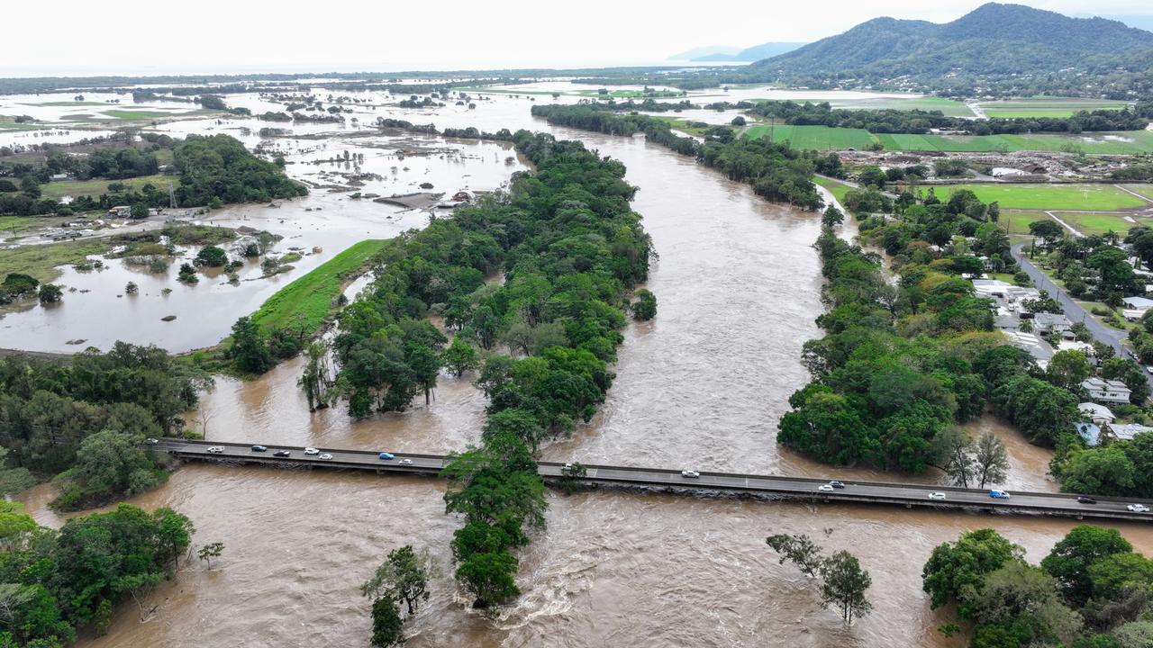 Flood waters lap at the Kamerunga bridge on the Western Road following Tropical Cyclone Jasper which made landfall on December 13. Picture: Brendan Radke