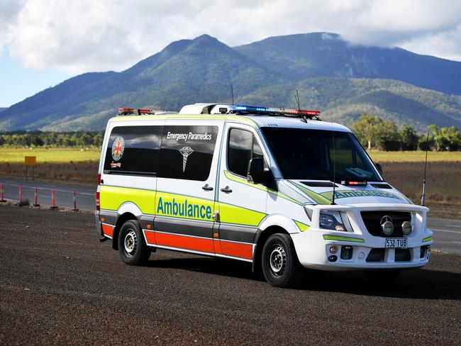 Emergency services attend a fatal car crash on the Bruce Highway, south of Townsville at Mount Surround. Garbage truck driver being looked over by paramedics.  Picture: Alix Sweeney