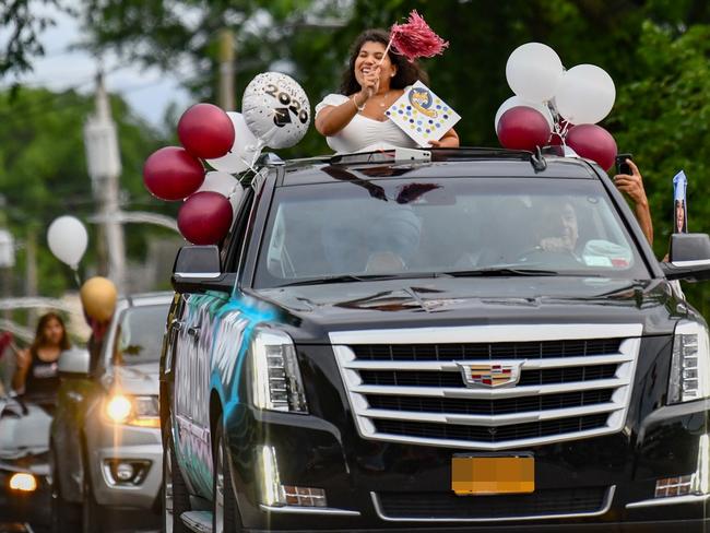 People celebrate a high school graduation drive-through parade in New York. Photo: EDL Photography