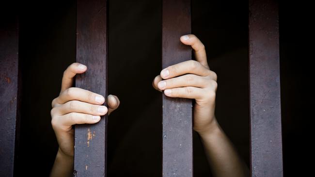 Prisoner, hands holding bars, jail, behind bars, children behind bars, asylum seeker generic, detention center, detained, jailed, shame, sadness, mental health, restriction, limitation generic, thinkstock