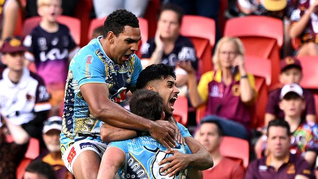 BRISBANE, AUSTRALIA - MAY 26: Chris Randall of the Titans is congratulated by team mates after scoring a try during the round 12 NRL match between Brisbane Broncos and Gold Coast Titans at Suncorp Stadium, on May 26, 2024, in Brisbane, Australia. (Photo by Bradley Kanaris/Getty Images)