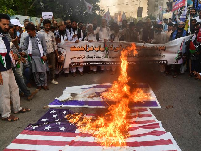 Protesters burn the national flags of US and Israel during an anti-Israel demonstration in Karachi. Picture: AFP