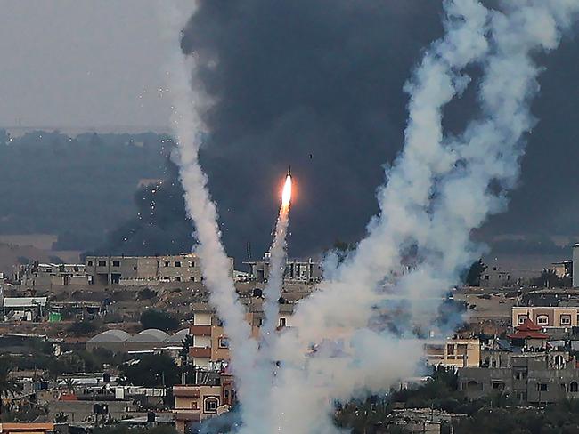 Palestinian militants fire rockets towards Israel from Rafah, southern Gaza Strip, on October 11, 2023. Israel on October 11 kept up its bombardment of Hamas targets in the Gaza Strip, as Prime Minister Benjamin Netanyahu and a political rival announced an emergency government for the duration of the conflict that has already killed thousands. (Photo by SAID KHATIB / AFP)