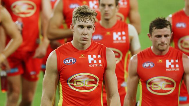 Tom Lynch leads his dejected teammates off Metricon Stadium after their loss to the Bulldogs. Picture: Scott Fletcher