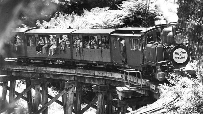 People hang outside the carriages in 1979 Train.