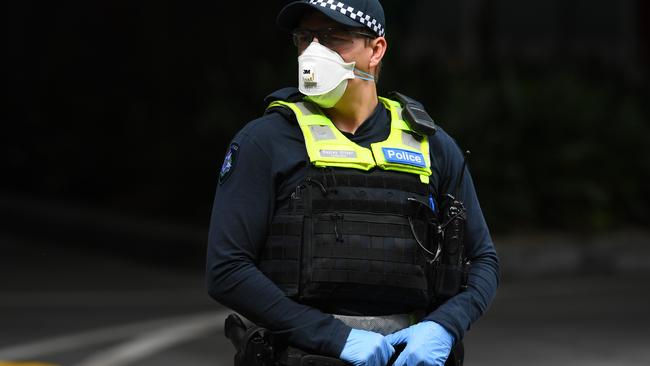 A Victorian Police officer wearing a face mask is seen outside of Crown Metropol Hotel in Melbourne where people arriving in Australia were sent straight to quarantine. Picture: Bianca De Marchi/AAP