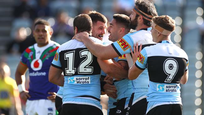 The Sharks celebrate a try to Shaun Johnson.