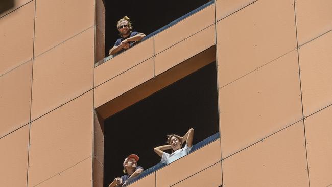 Quarantined expats pictured on the balconies at Peppers on Tuesday. Picture: NCA NewsWire / Roy VanDerVegt.