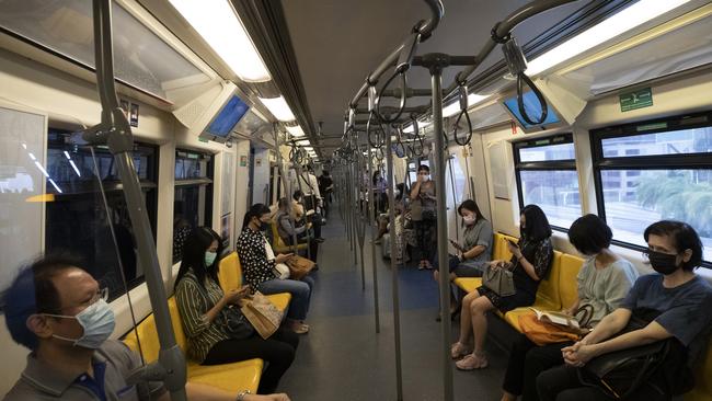 Commuters wear face masks to protect themselves. (AP Photo/Sakchai Lalit)