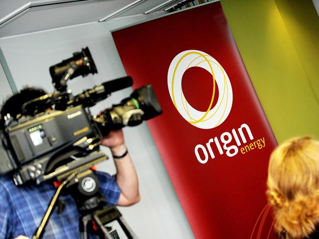 An Origin Energy logo (C) is displayed as a cameraman (L) films Origin Energy managing director Grant King (not pictured) delivering company half-year results in Sydney on February 25, 2010. Australia's Origin Energy on February 25 booked a 28 percent increase in underlying profit to 317 million USD as it expanded its electricity generation capacity and enjoyed good retail earnings.  AFP PHOTO / Greg WOOD