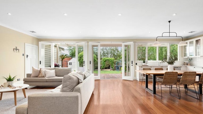 The substantial living room opens onto the back yard.