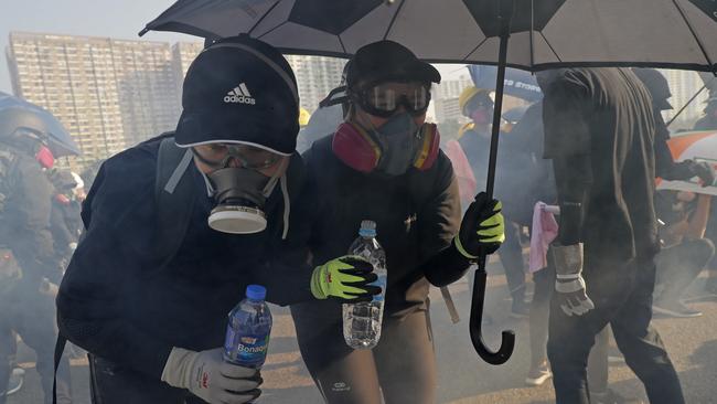 Police fire tear gas to disperse anti-government protesters outside police headquarters. Picture; AP.