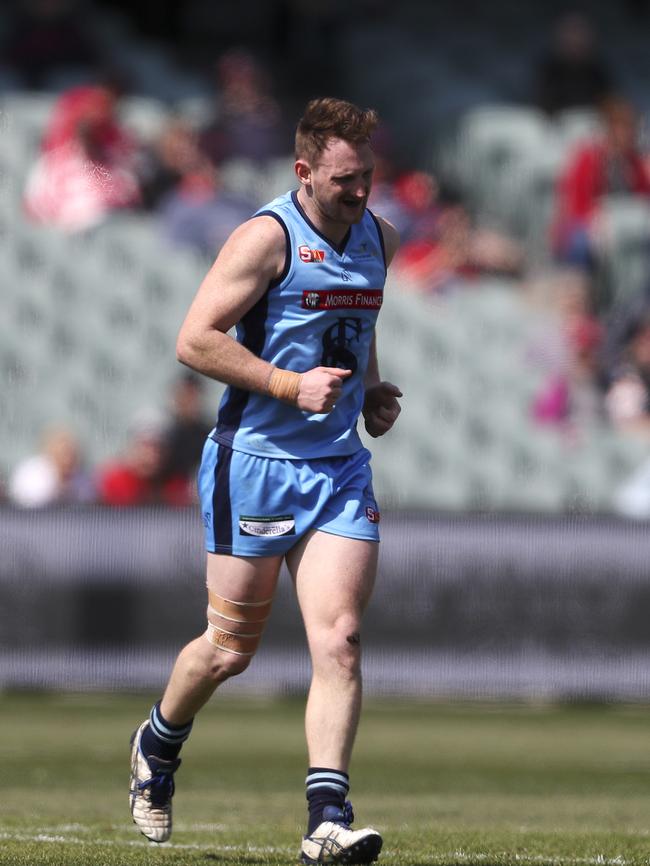 Aidan Riley limps off against North Adelaide. Picture Sarah Reed