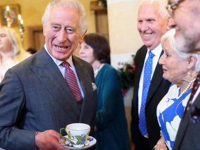 Britain's King Charles III reacts whilst holding a cup and saucer, as he meets with guests during a 75th birthday party for him, hosted by the Prince's Foundation, at Highgrove House in Tetbury, western England on November 13, 2023. Guests included local residents who have been nominated by friends and family and individuals and organisations also turning 75 in 2023. (Photo by Chris Jackson / POOL / AFP)