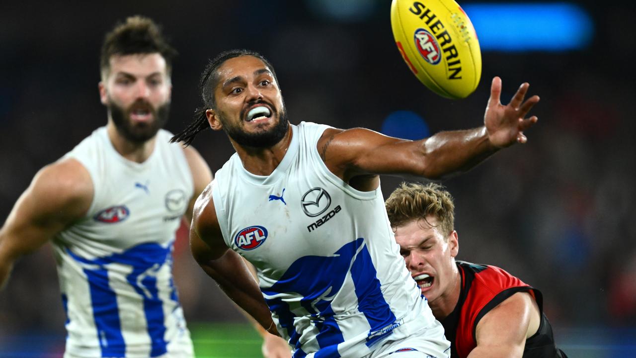 MELBOURNE, AUSTRALIA - JUNE 04: Aaron Hall of the Kangaroos is tackled during the round 12 AFL match between Essendon Bombers and North Melbourne Kangaroos at Marvel Stadium, on June 04, 2023, in Melbourne, Australia. (Photo by Quinn Rooney/Getty Images)