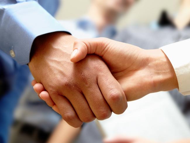 CAREERS: Image of business handshake after signing new contract.