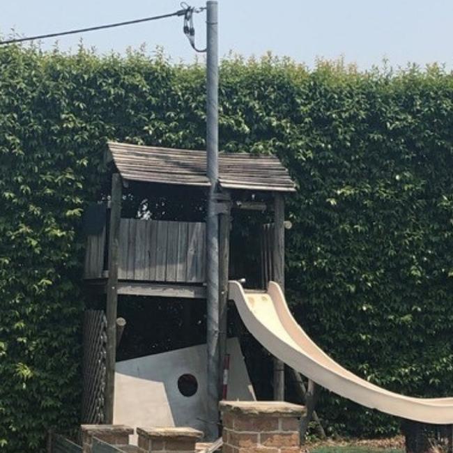 Power had to be switched off after an Ausgrid crew found this cubby house built around a power pole in a Seaforth backyard. Picture: Ausgrid