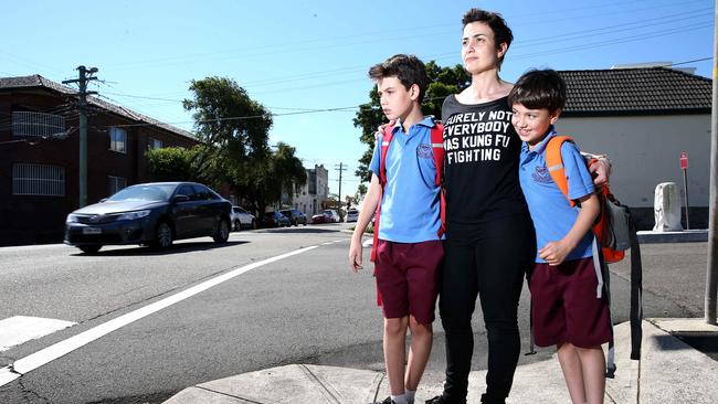 Shirin Town watches traffic with sons Gabe (left) and Dash after picking the boys up from their school Dulwich Hill Public.