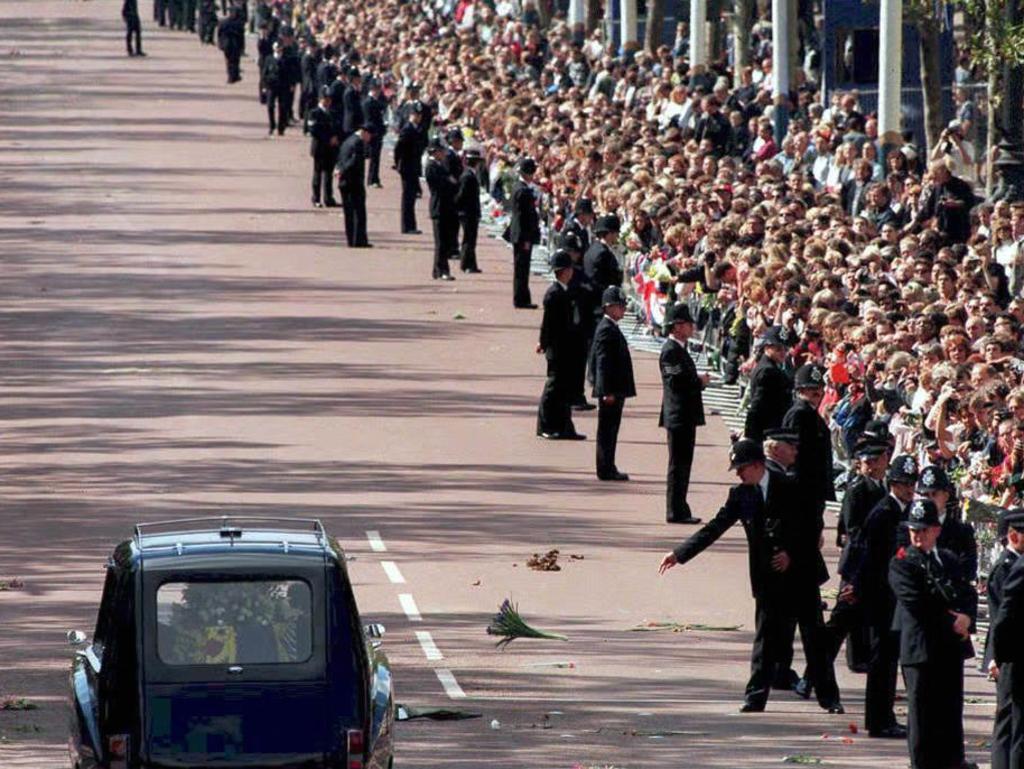 A policeman throws a bunch of flowers as the hearse carrying the coffin of Diana, Princess of Wales, down The Mall following the service at Westminster Abbey on September 6, 1997. Picture: AFP