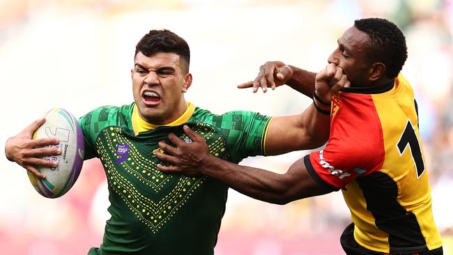 David Fifita bursts through the PNG defence during the World Cup 9’s. Picture: AAP Image/Brendon Thorne