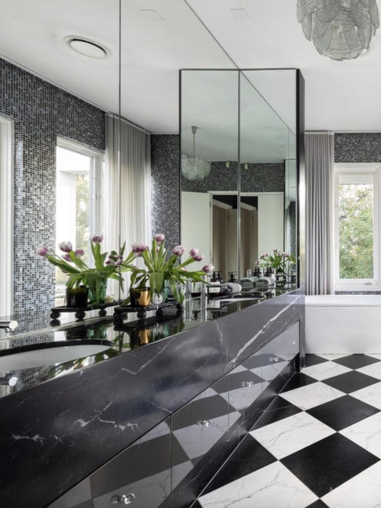 Bold designer bathrooms feature custom finishes, including chequered marble floors, mosaic tiles and luxe twin vanities.