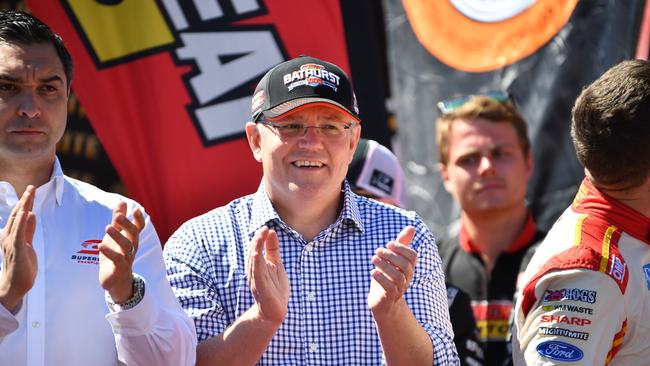 Australian Prime Minister Scott Morrison (centre) is seen during the Bathurst 1000 V8 Super Cars Championship at Mount Panorama Motor Racing Circuit in Bathurst, Sunday, October 7, 2018. The Bathurst 1000 is the most famed race in the V8 Super Car calendar, fought out over 1000kms, the event draws fans from all over the country to the New South Wales town of Bathurst. (AAP Image/Brendan Esposito) NO ARCHIVING,EDITORIAL USE ONLY