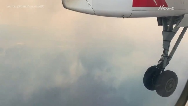 Qantas plane surrounded by thick smoke