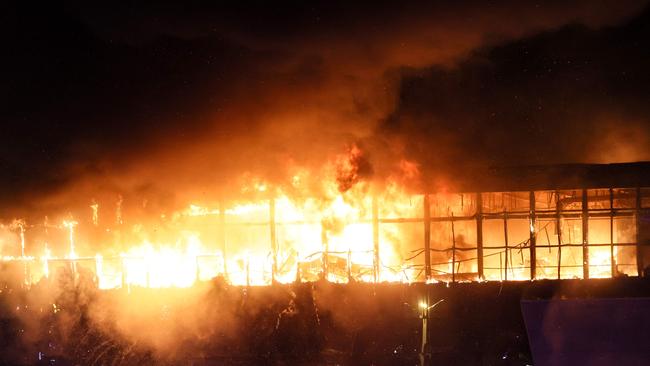 A view shows the burning Crocus City Hall concert hall following the shooting incident in Krasnogorsk, outside Moscow, on March 22, 2024. (Photo by STRINGER / AFP)