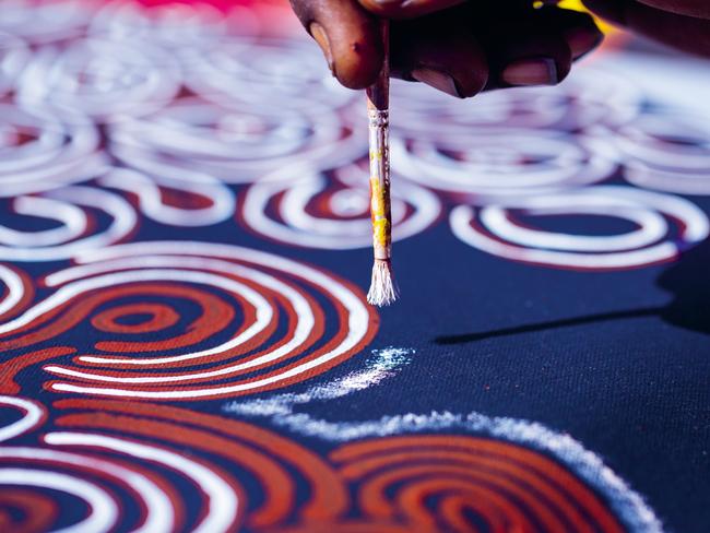 An Aboriginal artist working on a painting.The Maruku Arts gallery is located at the cultural centre in Uluru-Kata Tjuta National Park. We offer an overall understanding of local Aboriginal culture through quality art & craft. It is the perfect opportunity to meet, understand the culture and purchase works from local artists, knowing that all funds are returned to the Anangu people.credit: Felix Bakerescape12 december 2021destination Uluru