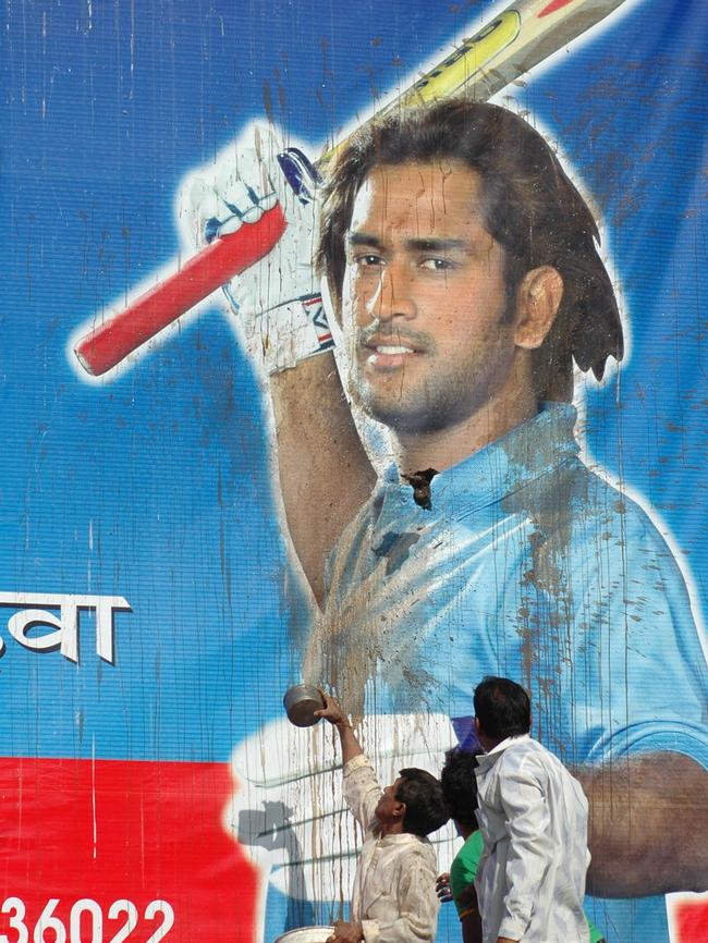 Fans throw mud on a billboard featuring MS Dhoni in Ahmedabad after India were knocked out of the 2007 World Cup. Photo: AP Photo