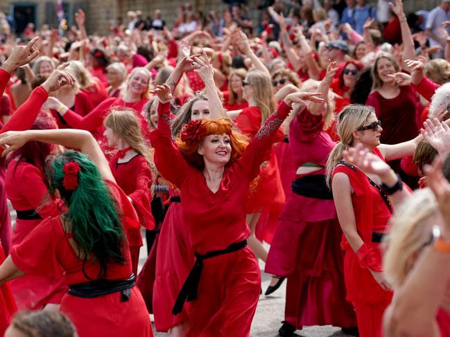 Heathcliff, it’s me, I’m Cathy! Dressed in red, Kate Bush fans take part in a mass dance event for the Most Wuthering Heights Day Ever, in the UK. Picture: Gareth Fuller/PA Images