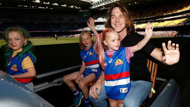 Liam Picken of the Bulldogs completes a lap of honour with his children after announcing his retirement in 2019. Picture: Michael Willson/AFL Photos/Getty Images