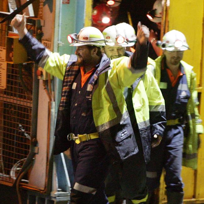 Rescued miners Todd Russell (front) and Brant Webb wave as they walk from the lift after they were rescued.