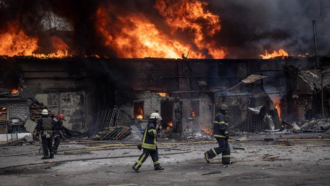 Firefighters work to extinguish a fire at a warehouse after it was hit by Russian shelling in Kharkiv, Ukraine, in March. Picture: Getty Images