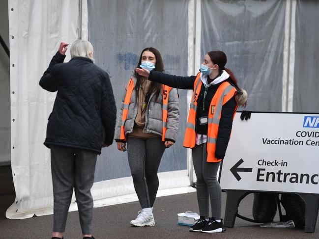 Workers at a COVID-19 vaccine hub at the Colchester Community Stadium in south east England. Picture: AFP