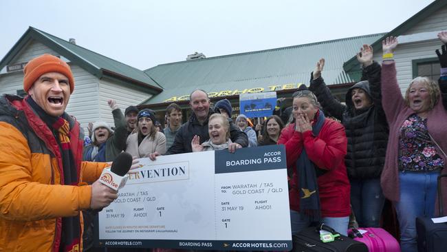 Sunrise weather man Sam Mac announces to Waratah residents they will all be flying to the Gold Coast on an all expenses paid trip. Picture: Chris Kidd.