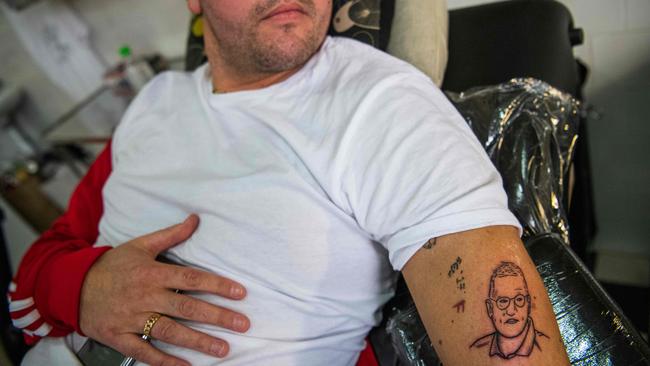 Gustav Lloyd Agerblad looks at his new tattoo of Sweden's state epidemiologist Anders Tegnell, the face of the country's response to the novel coronavirus COVID-19 pandemic.