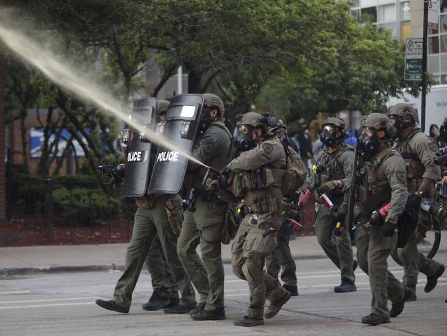 Police react as protesters in Chicago take to the streets after a march and rally over the death of George Floyd. Picture: AP