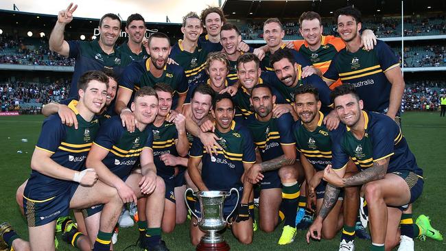 The Australian team pose with the Cormac McAnallen trophy after winning game two and the series of the International Rules Series.