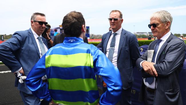 Jockey Tyler Schiller speaks to Gallo Nero’s connections, including co-trainer Michael Hawkes (second from left) and part owner Neil Werrett (right), after the colt’s victory at Randwick on Saturday. Picture: Jeremy Ng / Getty Images