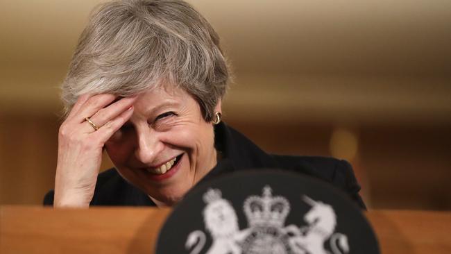 Theresa May laughs during a press conference inside 10 Downing Street after the resignation of Cabinet ministers. Picture: Getty Images