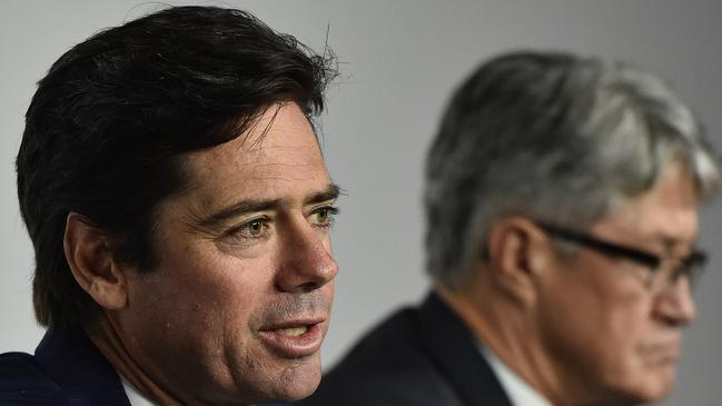 Gillon McLachlan (left) and Mike Fitzpatrick speak to the media after WADA found 34 Essendon players guilty of using performance enhancing drugs. (AAP Image/Julian Smith)